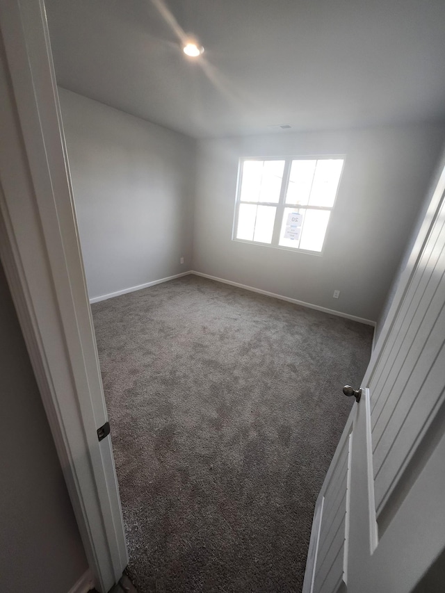 carpeted empty room featuring baseboards and recessed lighting