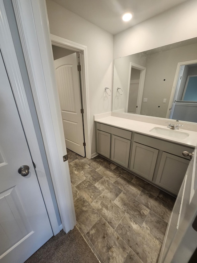bathroom featuring stone finish floor and vanity