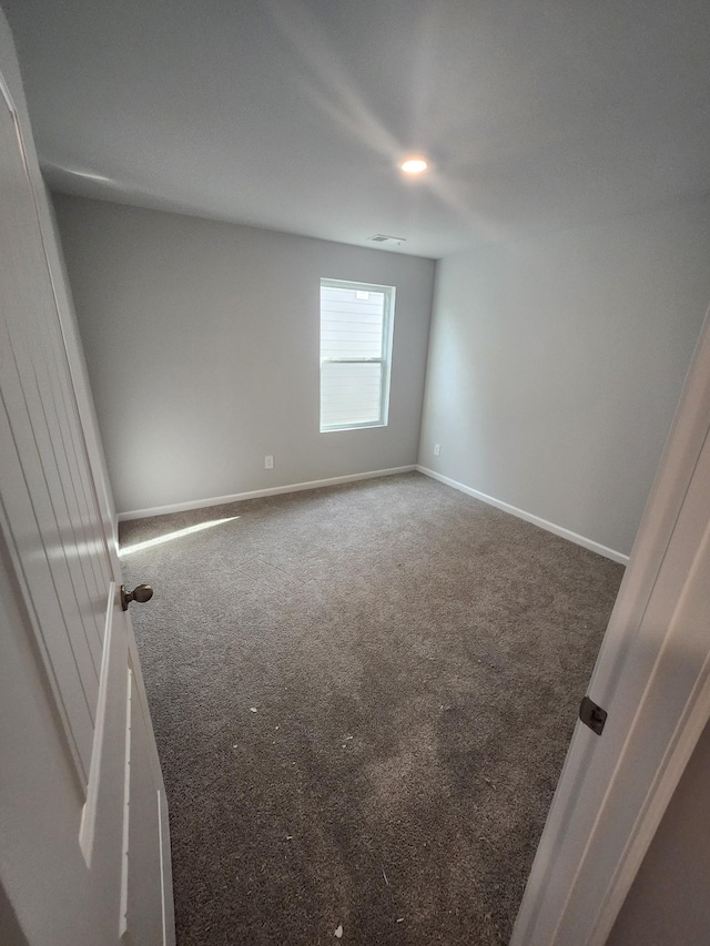 empty room with baseboards, carpet, and visible vents