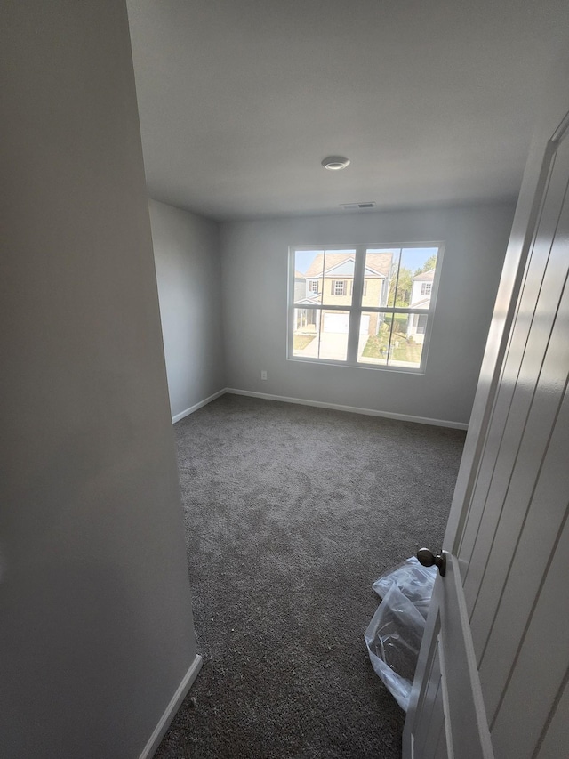 empty room with carpet floors and baseboards