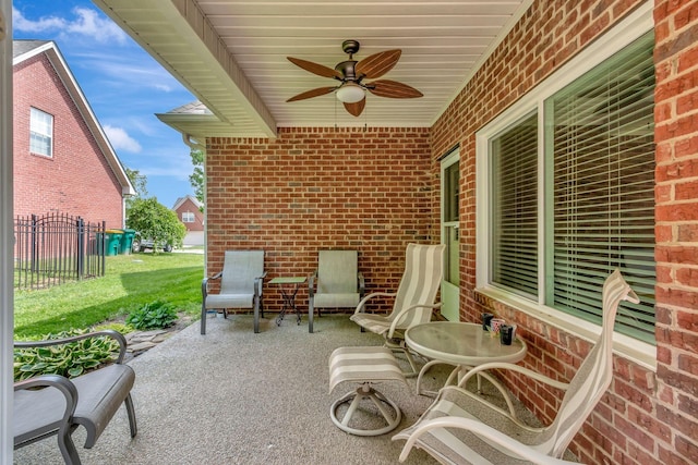 view of patio / terrace featuring ceiling fan and fence