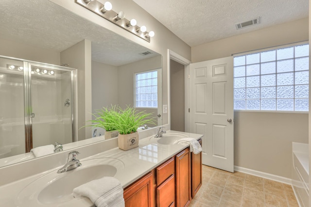 2039 Caladonia Way, Smyrna, TN 37167 - bathroom with a sink, a shower stall, a textured ceiling, and visible vents