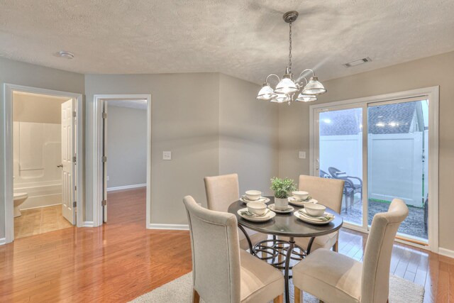 2039 Caladonia Way, Smyrna, TN 37167 - dining space featuring baseboards, visible vents, light wood-type flooring, and a notable chandelier