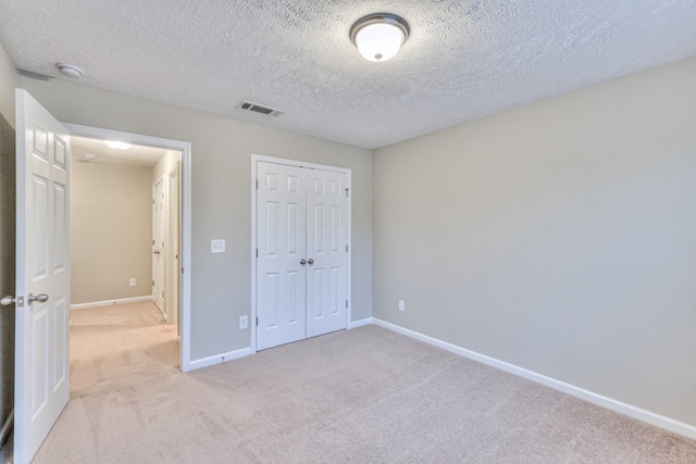 2039 Caladonia Way, Smyrna, TN 37167 - unfurnished bedroom featuring visible vents, a closet, light carpet, baseboards, and a textured ceiling