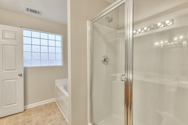 2039 Caladonia Way, Smyrna, TN 37167 - bathroom featuring visible vents, baseboards, a garden tub, and a shower stall