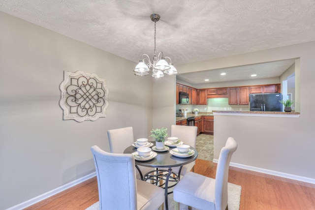 2039 Caladonia Way, Smyrna, TN 37167 - dining room featuring baseboards, recessed lighting, a textured ceiling, light wood-style flooring, and a notable chandelier