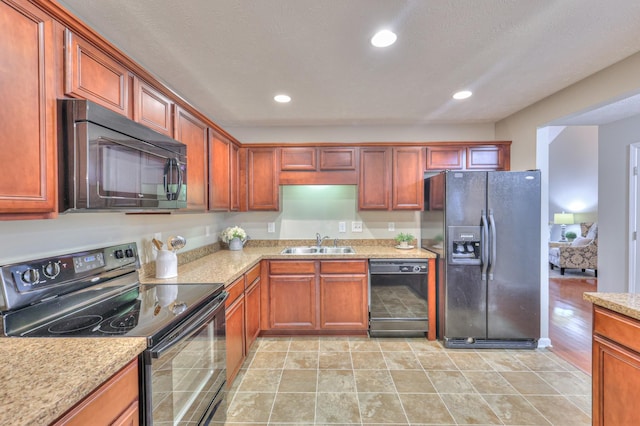 2039 Caladonia Way, Smyrna, TN 37167 - kitchen featuring recessed lighting, light stone countertops, a sink, and black appliances