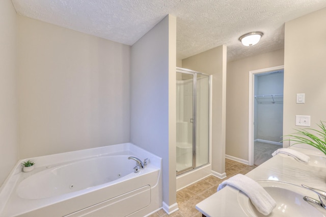 2039 Caladonia Way, Smyrna, TN 37167 - bathroom featuring a whirlpool tub, a textured ceiling, a shower stall, and a walk in closet