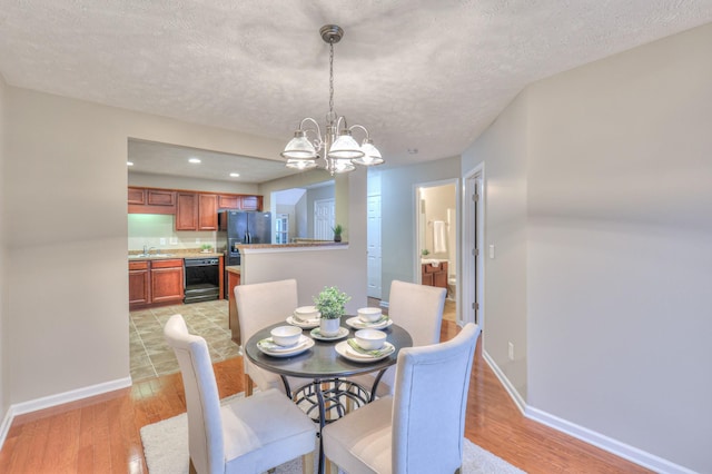 2039 Caladonia Way, Smyrna, TN 37167 - dining space with an inviting chandelier, baseboards, recessed lighting, a textured ceiling, and light wood-style flooring