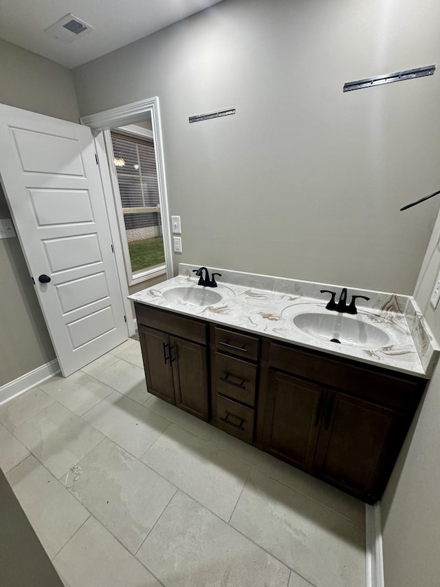bathroom with double vanity and a sink