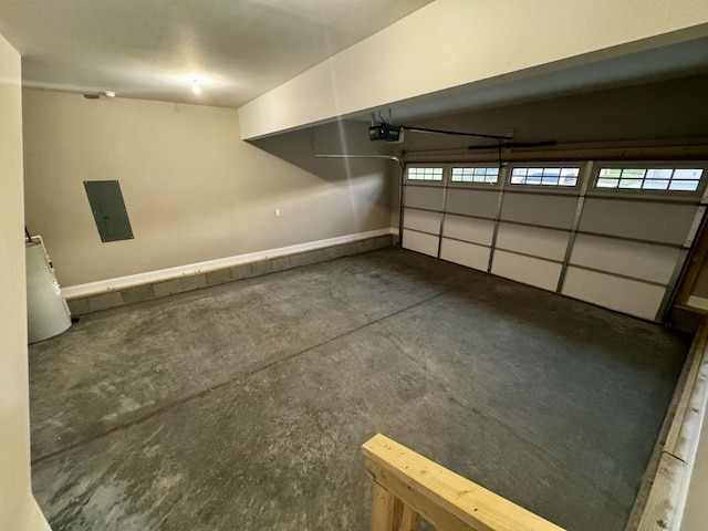 garage featuring baseboards, a garage door opener, and electric panel