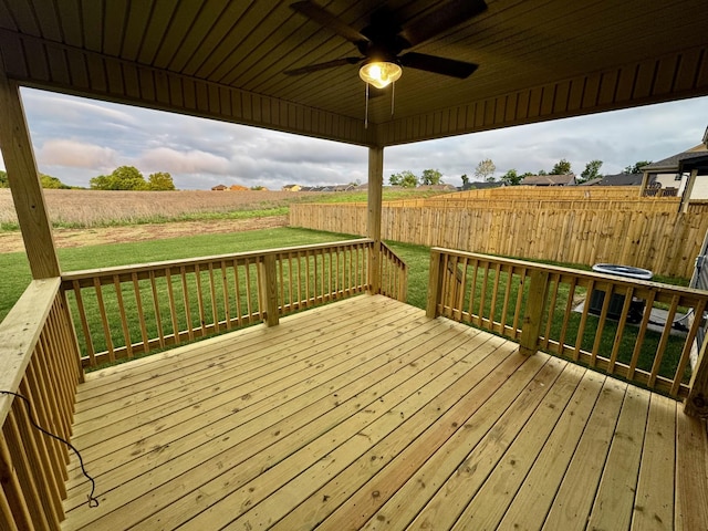 deck featuring a fenced backyard, ceiling fan, and a yard