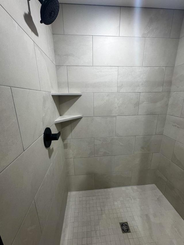 bathroom with a tile shower