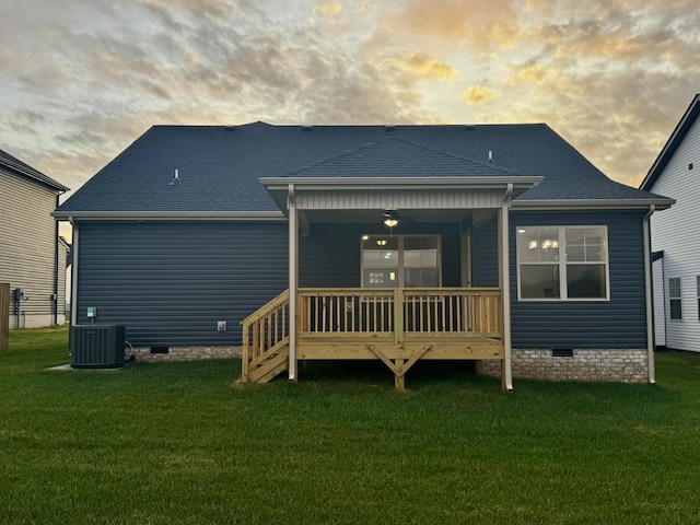 back of property with a lawn, cooling unit, and crawl space