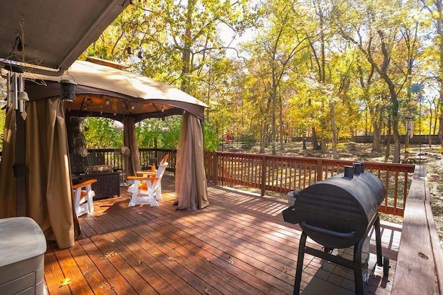 wooden deck featuring a gazebo and area for grilling