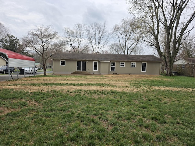 back of property with a lawn
