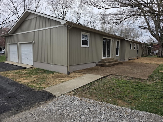 view of home's exterior featuring driveway, crawl space, and entry steps