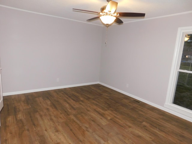 empty room with baseboards, ornamental molding, dark wood-style flooring, and ceiling fan