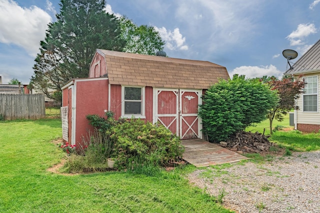 view of shed featuring fence