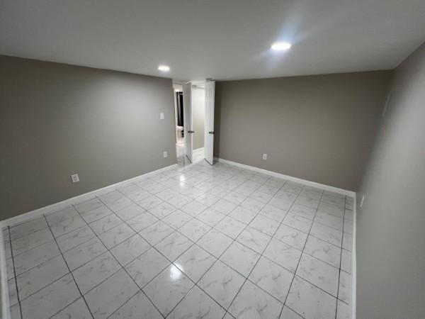 interior space featuring recessed lighting and baseboards