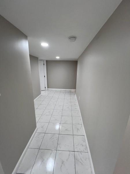 corridor with recessed lighting, baseboards, and marble finish floor