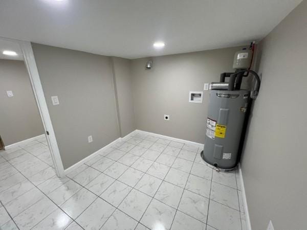 finished below grade area with baseboards, recessed lighting, and electric water heater