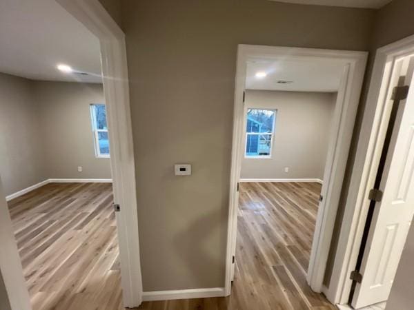hall featuring baseboards and wood finished floors