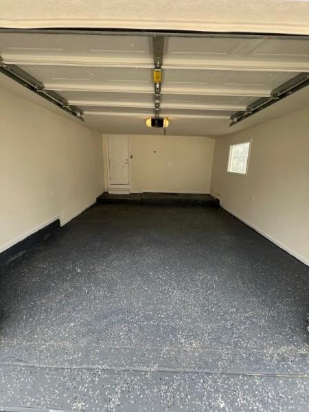 garage featuring baseboards and a garage door opener