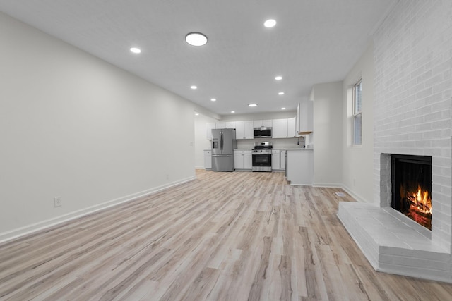 846 Forrest Glen Dr, Old Hickory, TN 37138 - unfurnished living room featuring recessed lighting, baseboards, light wood-type flooring, and a fireplace