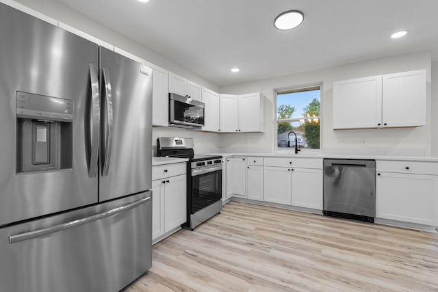 846 Forrest Glen Dr, Old Hickory, TN 37138 - kitchen with light wood-type flooring, a sink, light countertops, stainless steel appliances, and white cabinetry