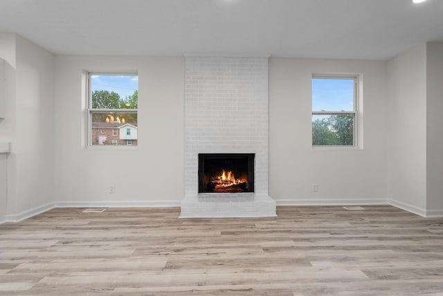 846 Forrest Glen Dr, Old Hickory, TN 37138 - unfurnished living room featuring baseboards, light wood-style flooring, a wealth of natural light, and a fireplace