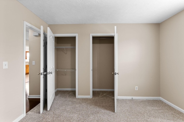 unfurnished bedroom with baseboards, carpet, and a textured ceiling