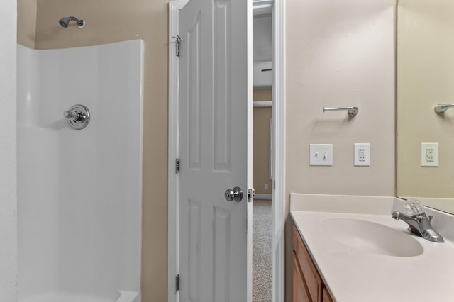 bathroom with vanity and a shower