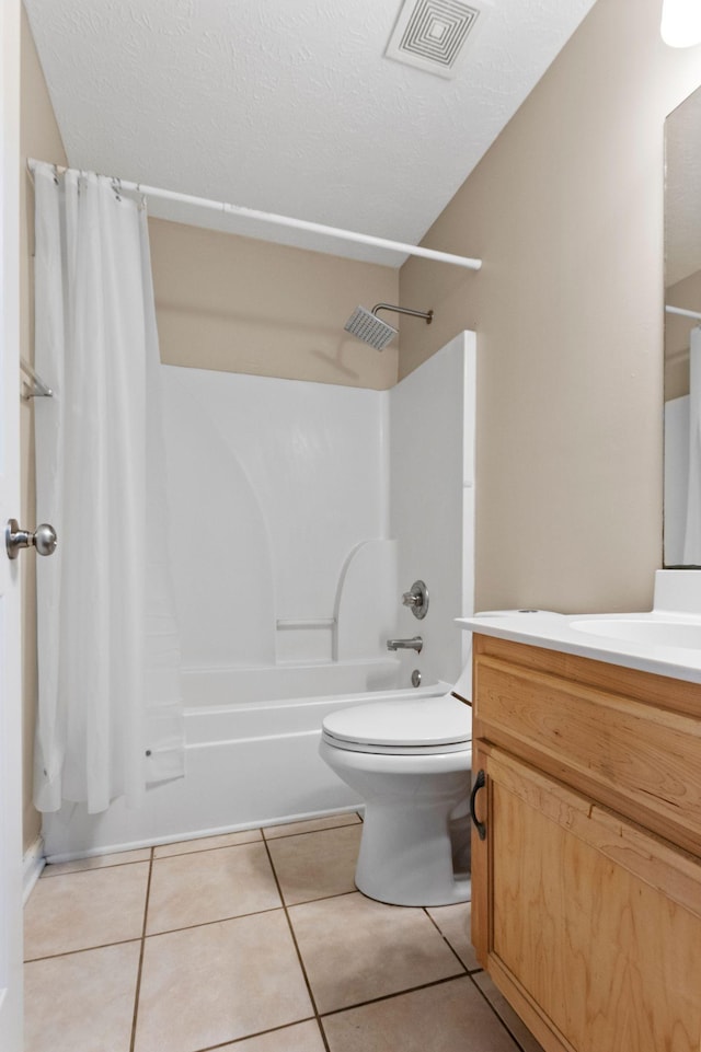bathroom featuring visible vents, tile patterned flooring, vanity, toilet, and shower / tub combo
