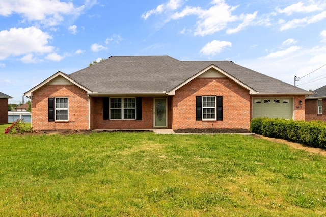ranch-style home with brick siding, a garage, and a front lawn