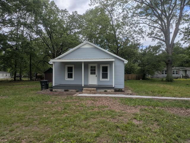 bungalow featuring a porch, fence, and a front yard