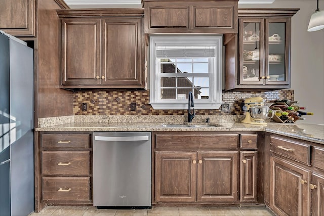 bar featuring appliances with stainless steel finishes, decorative backsplash, and a sink