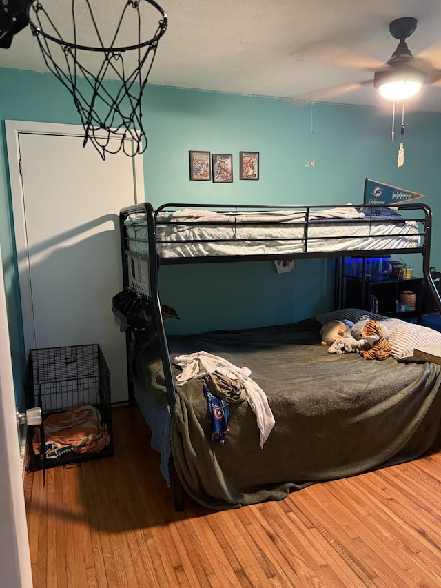 bedroom with ceiling fan and hardwood / wood-style flooring