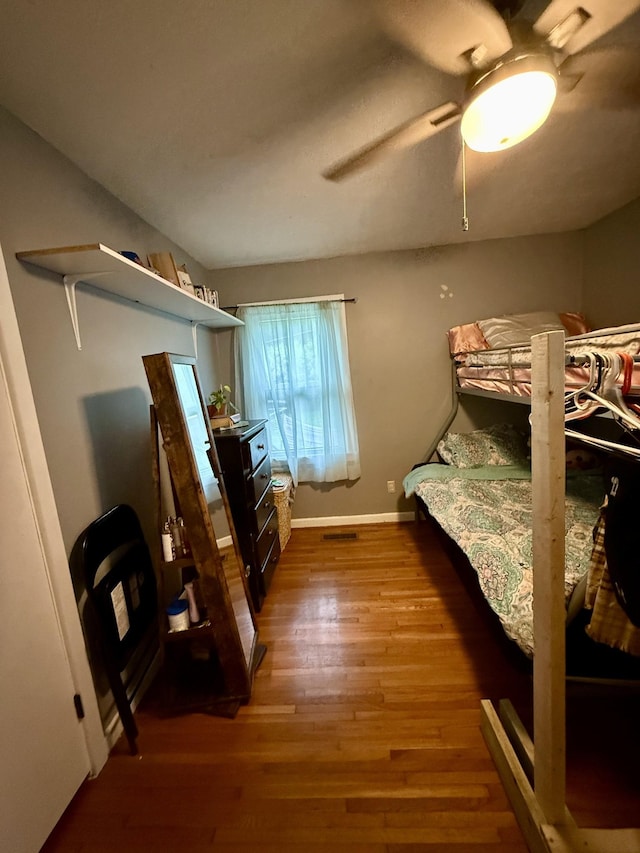 bedroom with baseboards, ceiling fan, and wood finished floors