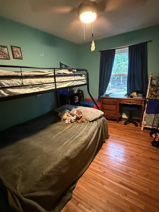 bedroom featuring a ceiling fan and hardwood / wood-style flooring