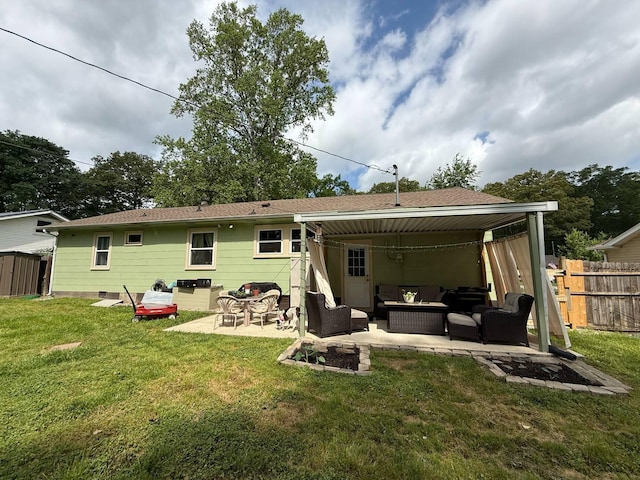 rear view of property with fence, a yard, a patio, and an outdoor living space