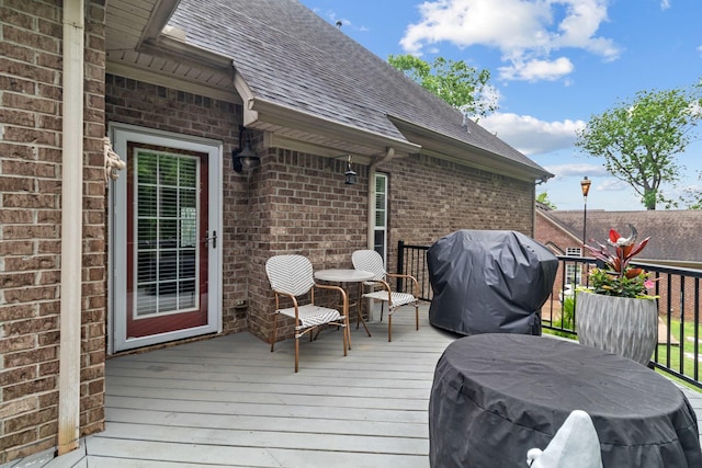 wooden deck with a grill