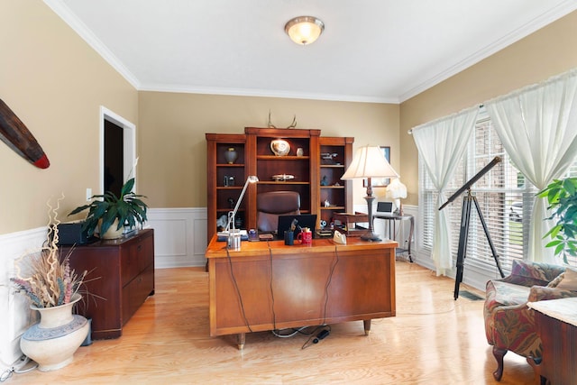 office area featuring crown molding, light wood-type flooring, and a wainscoted wall
