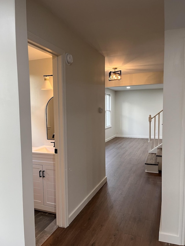 361 Binkley Dr, Nashville, TN 37211 - hallway with dark wood-type flooring, stairs, baseboards, a sink, and a chandelier