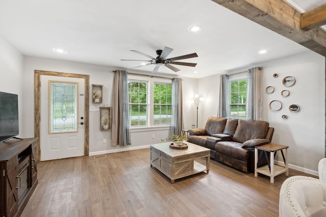 living room featuring baseboards, a ceiling fan, recessed lighting, and light wood-type flooring