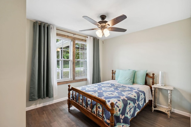 bedroom featuring baseboards, a ceiling fan, and dark wood-type flooring