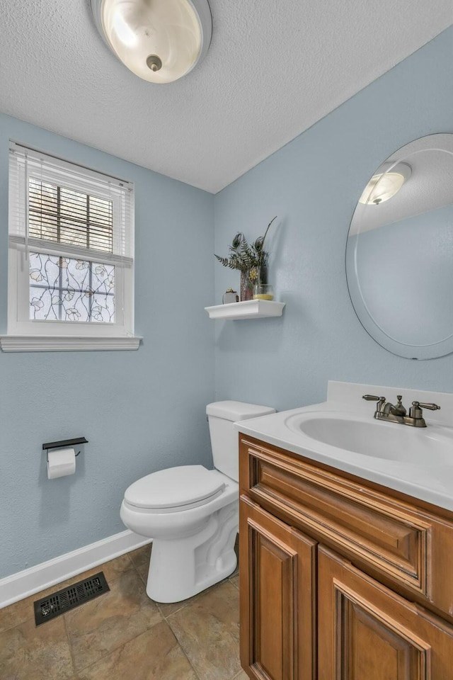 1204 Wood Pines Ln, Hixson, TN 37343 - bathroom featuring a textured ceiling, toilet, baseboards, and vanity