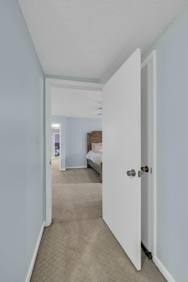1204 Wood Pines Ln, Hixson, TN 37343 - hallway featuring carpet flooring, baseboards, and a textured ceiling