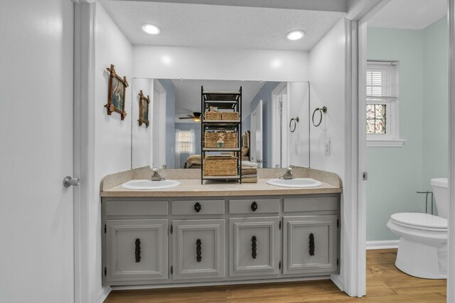 1204 Wood Pines Ln, Hixson, TN 37343 - full bath featuring ensuite bath, double vanity, toilet, wood finished floors, and ceiling fan