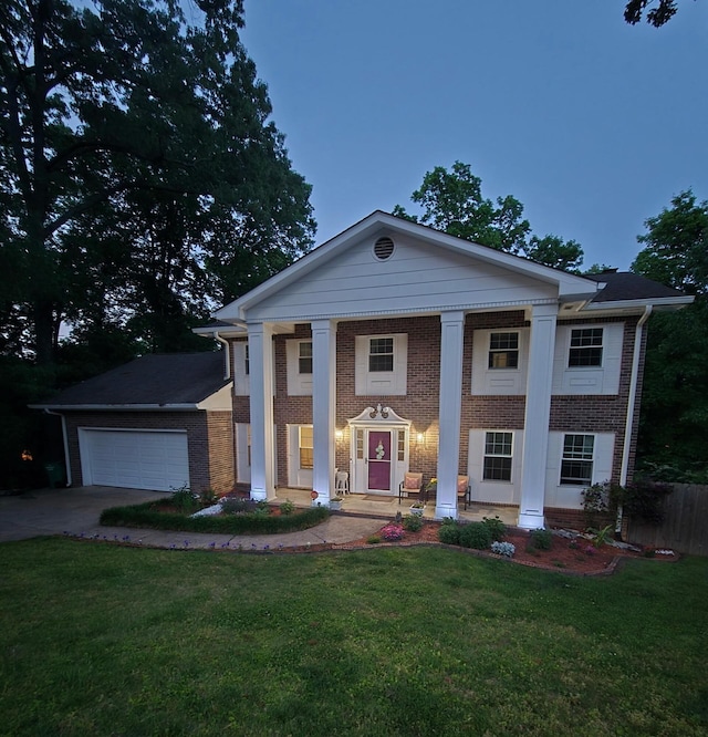 1204 Wood Pines Ln, Hixson, TN 37343 - greek revival house with brick siding, an attached garage, concrete driveway, and a porch